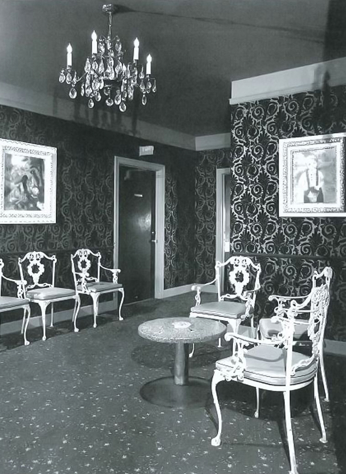 a room with chairs and a chandelier