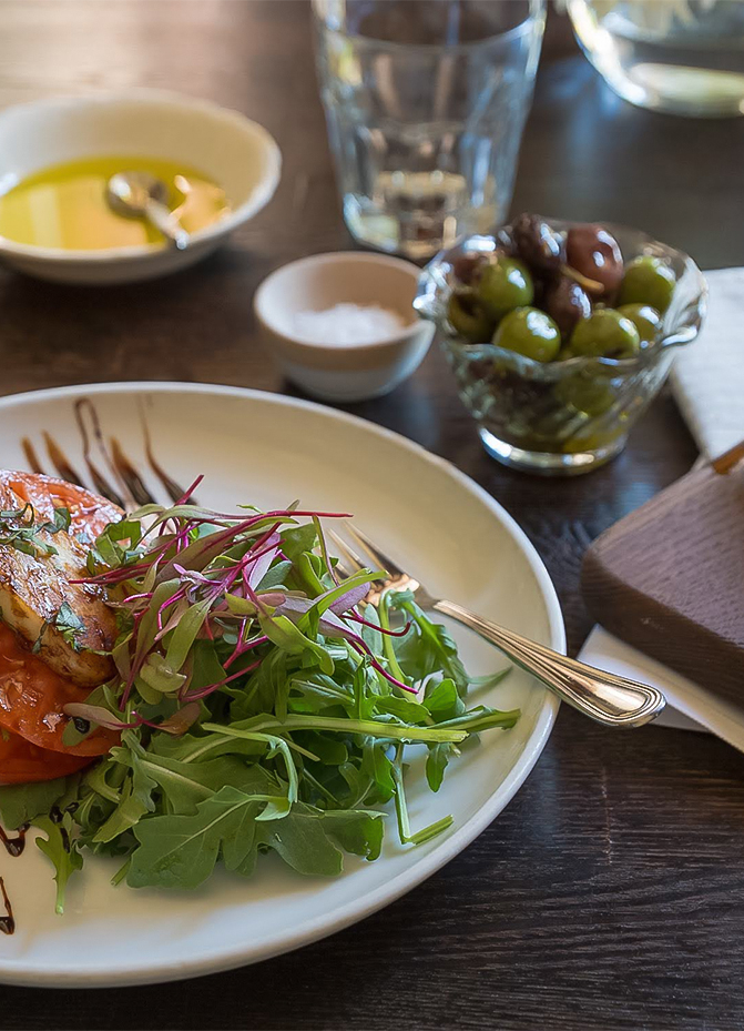 a plate of salad and olives