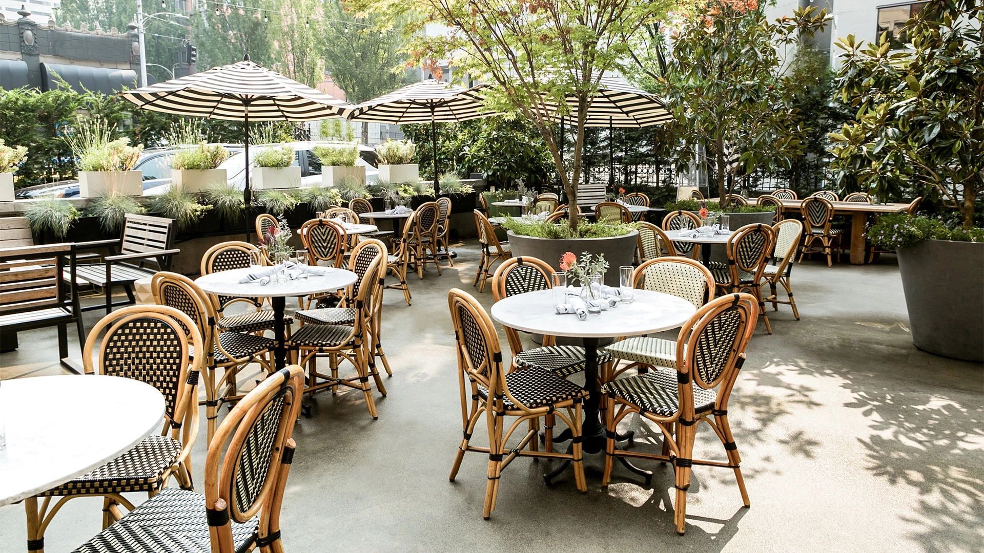 A outdoor seating area with tables and chairs