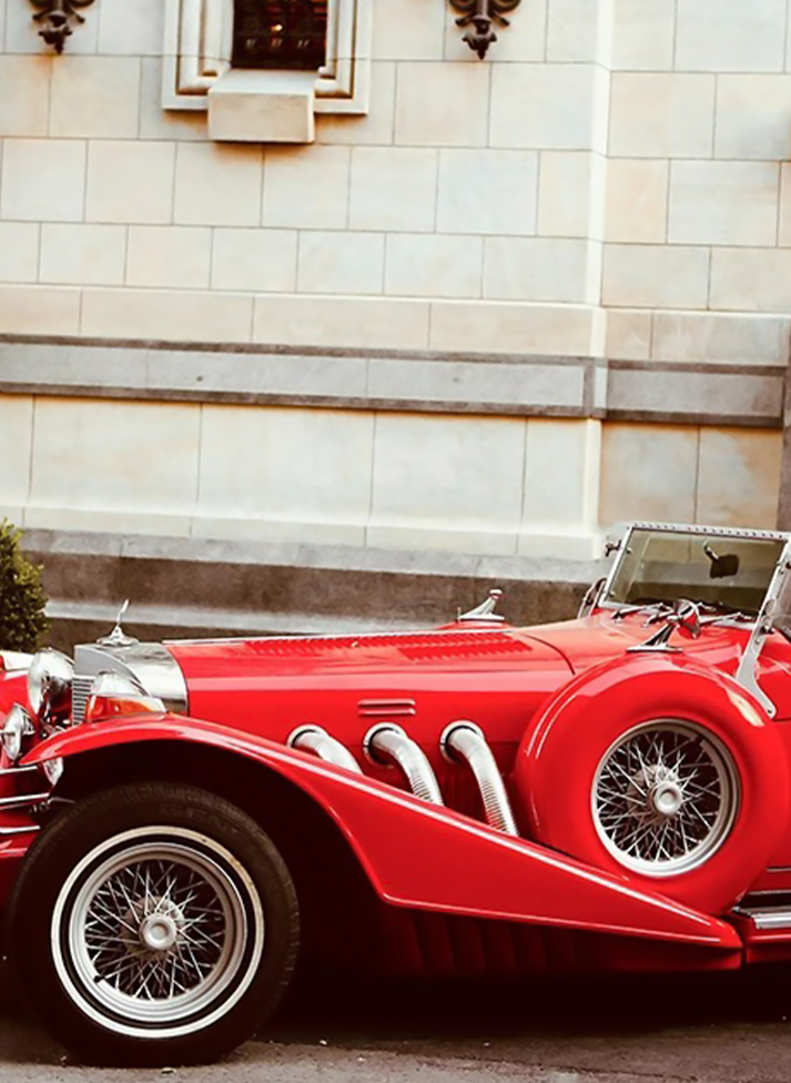 a red car parked in front of a building