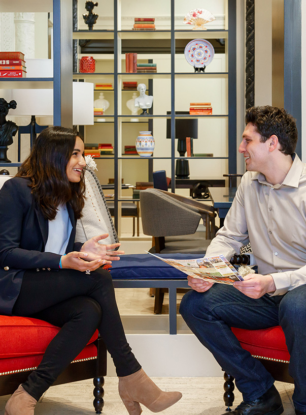 a man and woman sitting in chairs talking