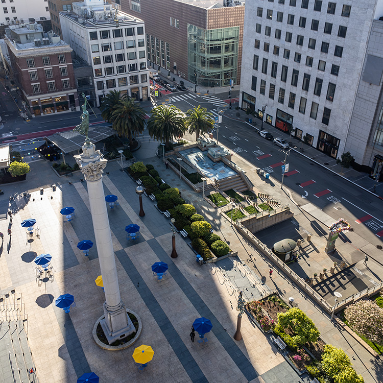 a city with a statue and a fountain