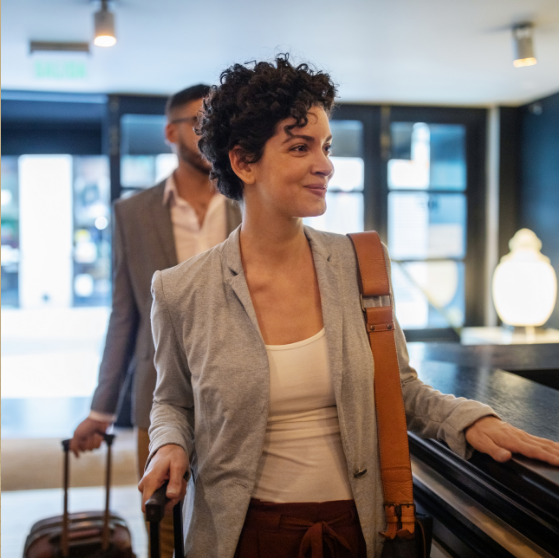a woman with a suitcase and a man in a suit