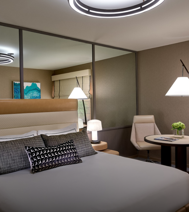 a bed with a table and chairs in a hotel room