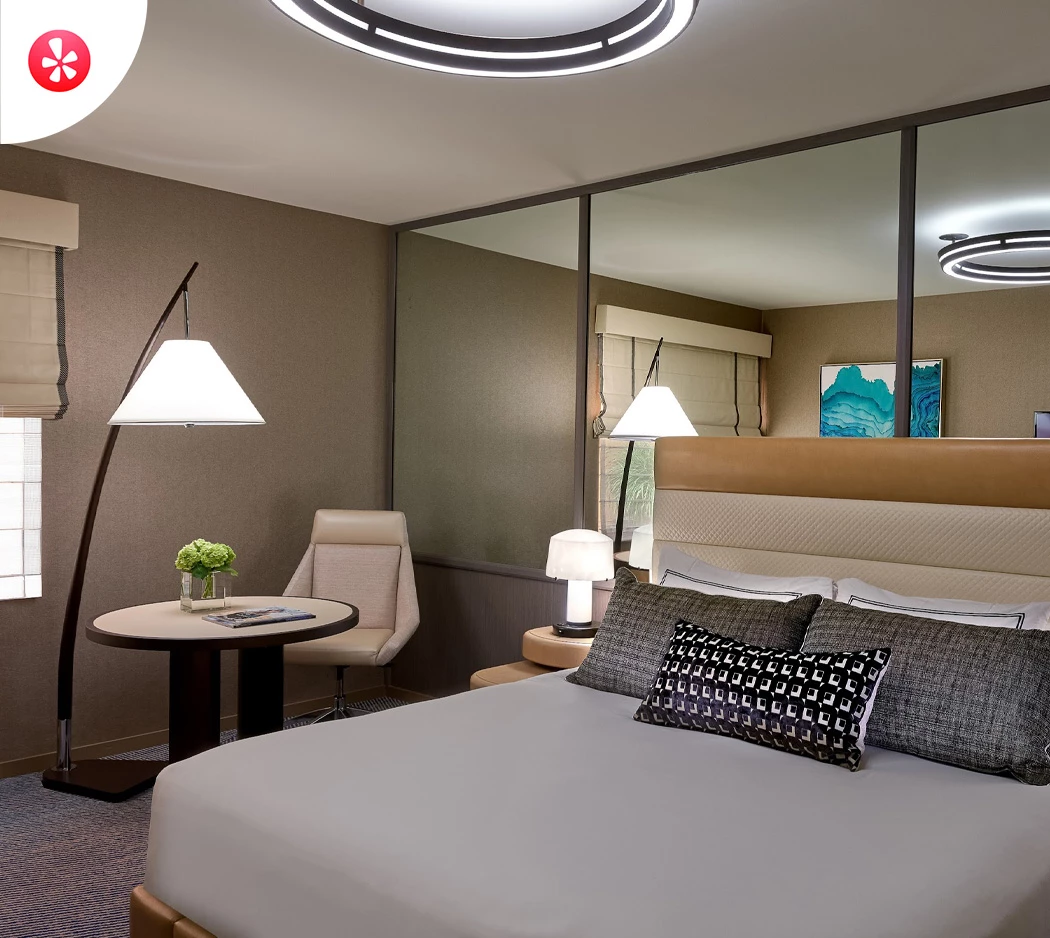 a bedroom with a large mirror and a bed