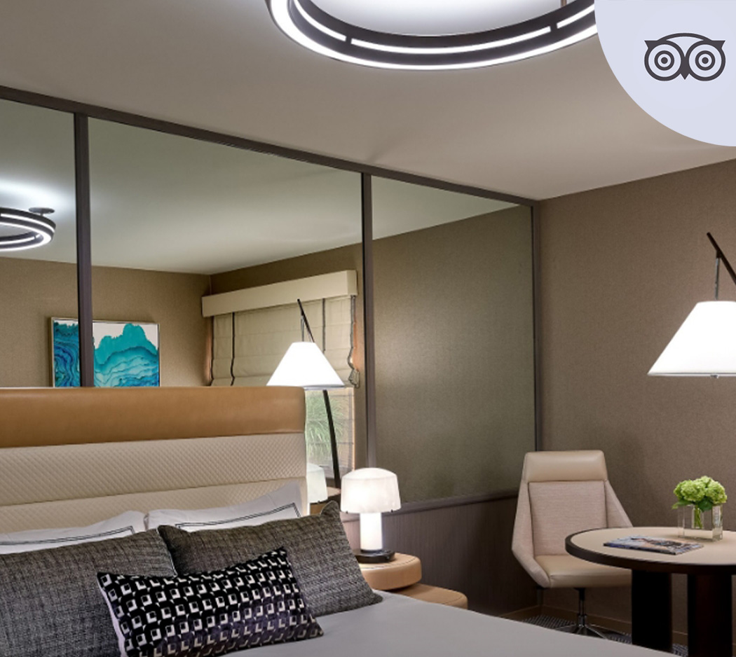 a room with a bed and chairs