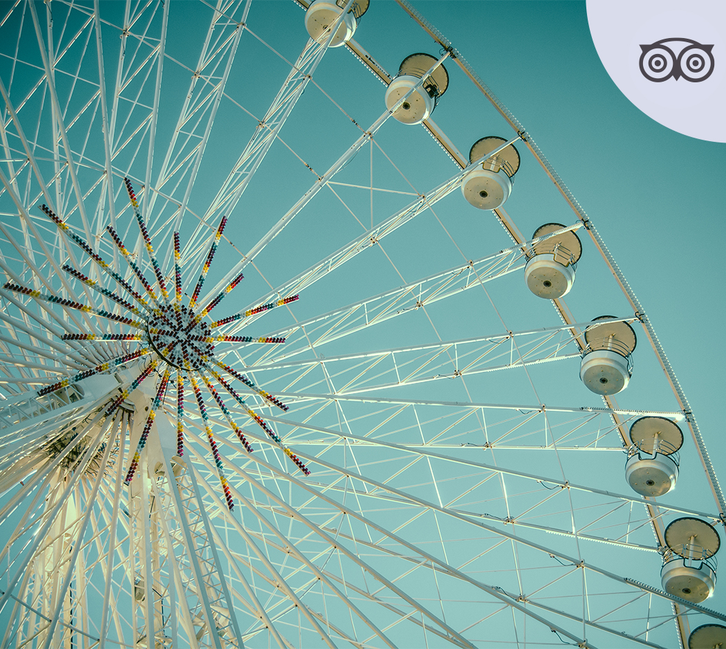 a ferris wheel with many white seats