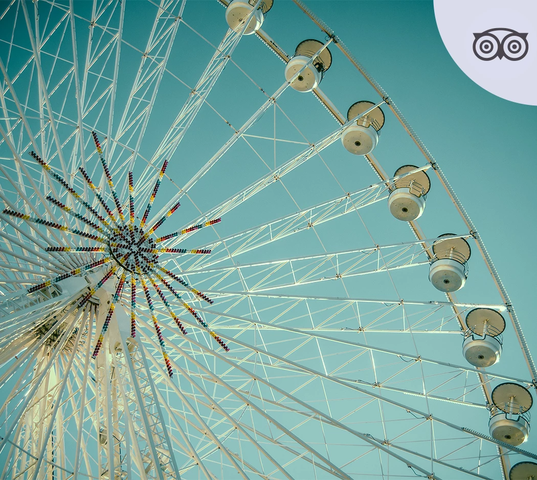 a ferris wheel with many white seats
