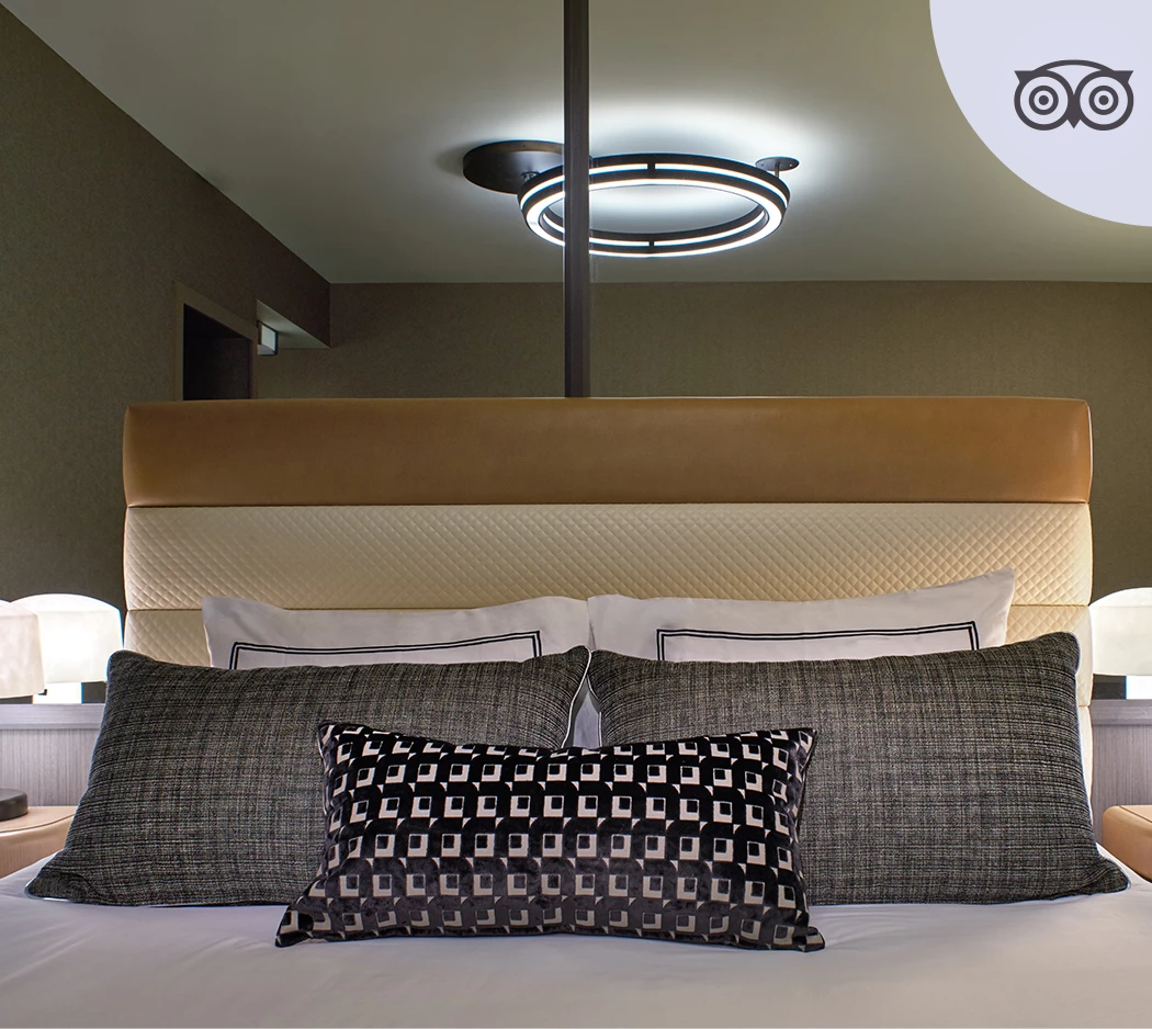 a bed with pillows and a lamp