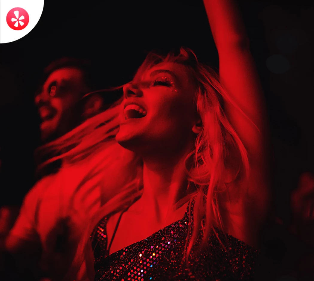 a woman with her arms raised in the air