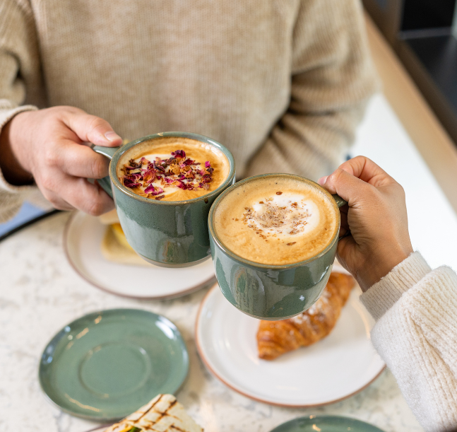 a person holding a cup of coffee