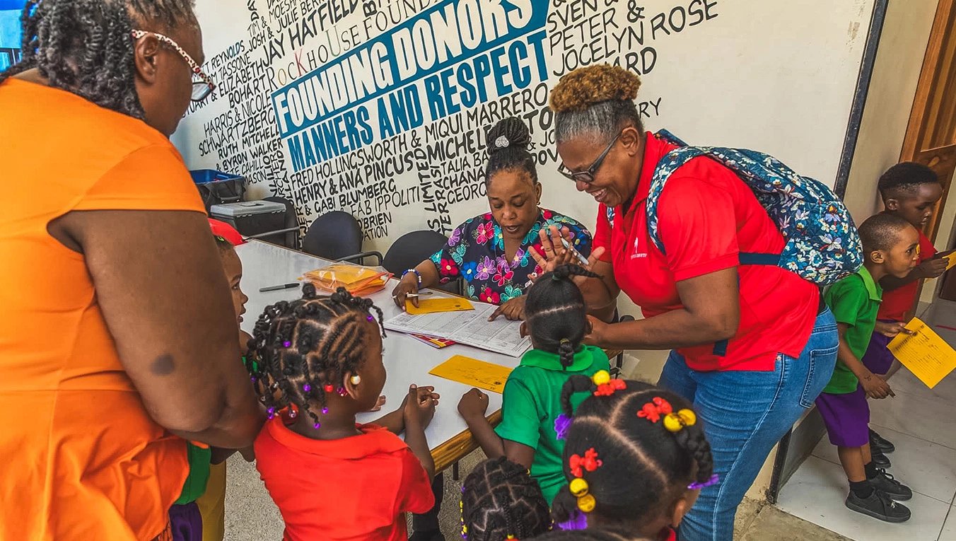 a woman and children sitting at a table