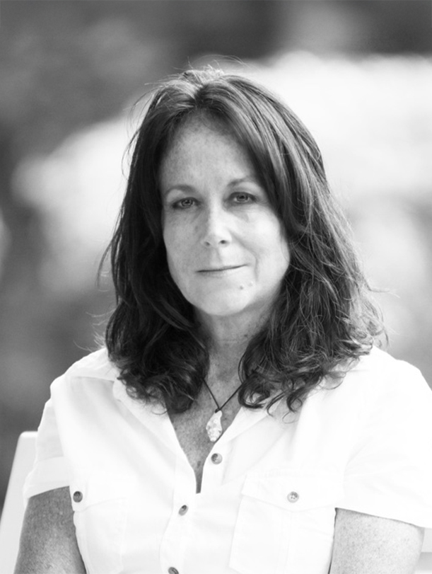 a woman with long hair wearing a white shirt