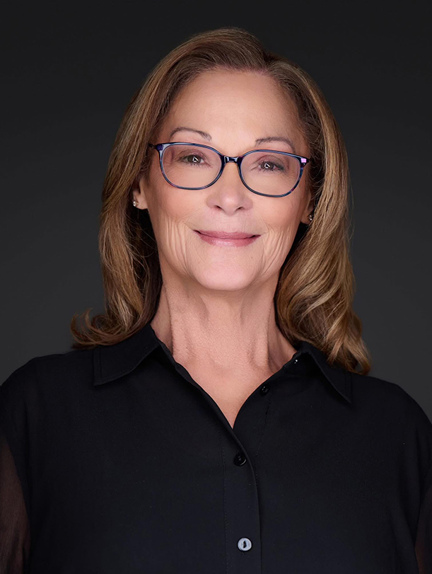 a woman wearing glasses and smiling