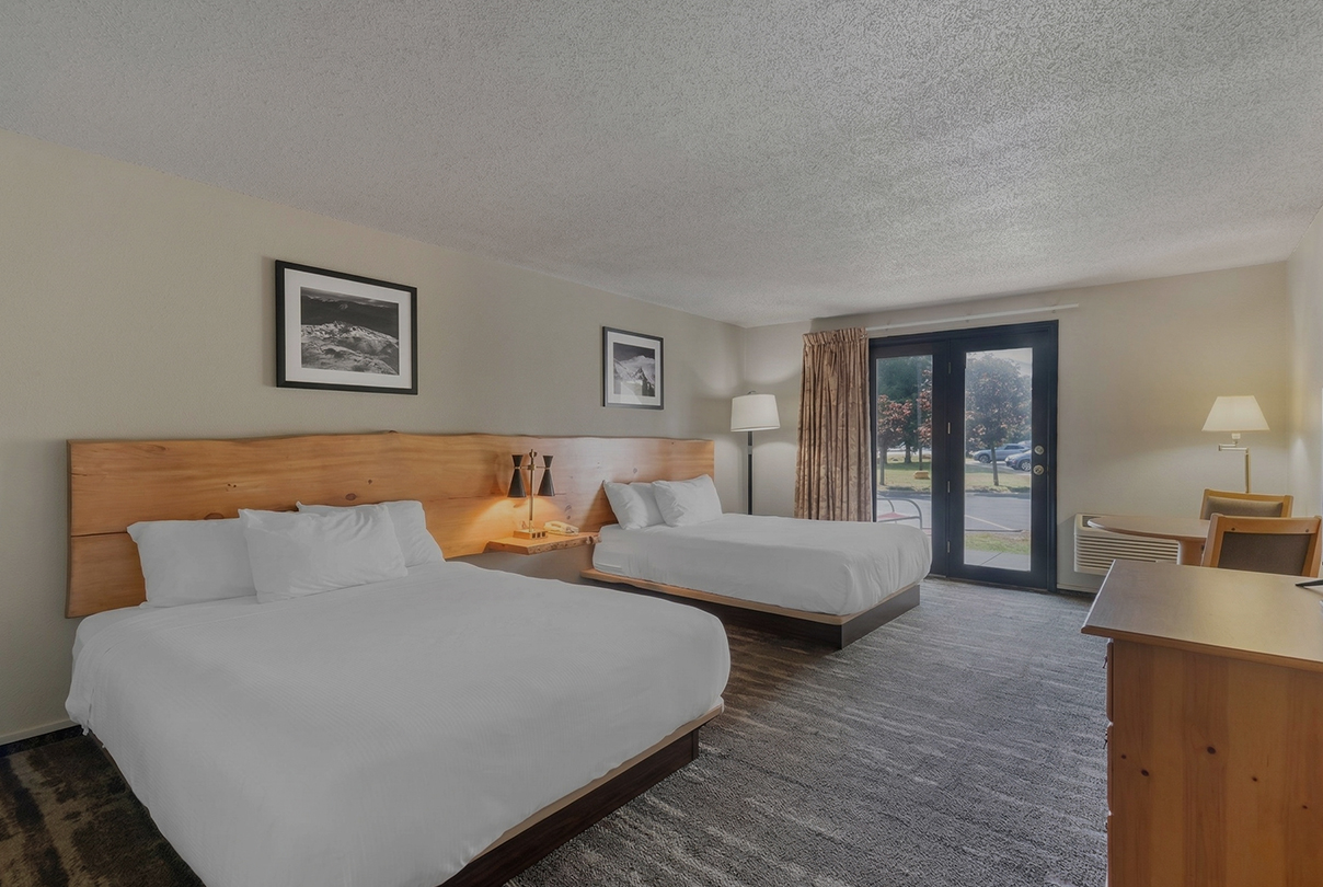 a room with two beds and a door