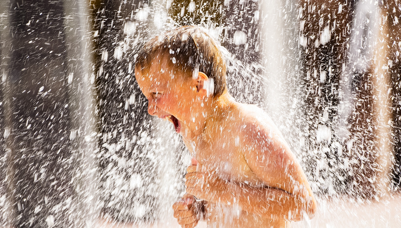 a boy in a water spout