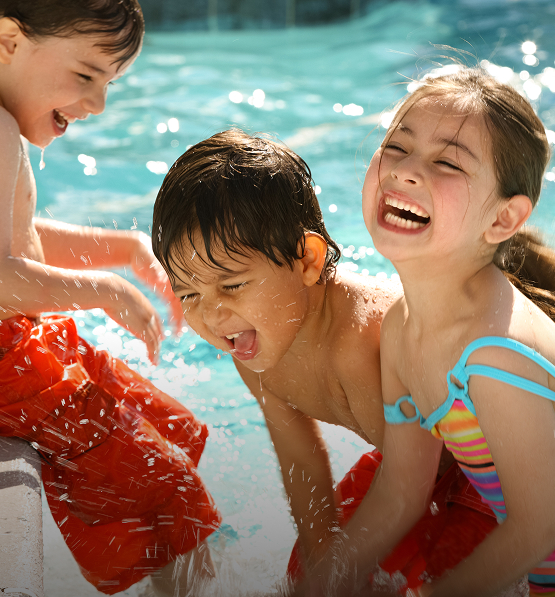 a group of children playing in a pool