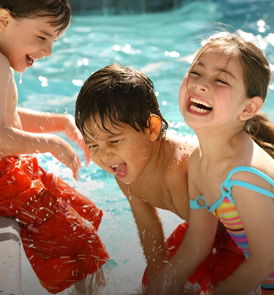 a group of children playing in a pool
