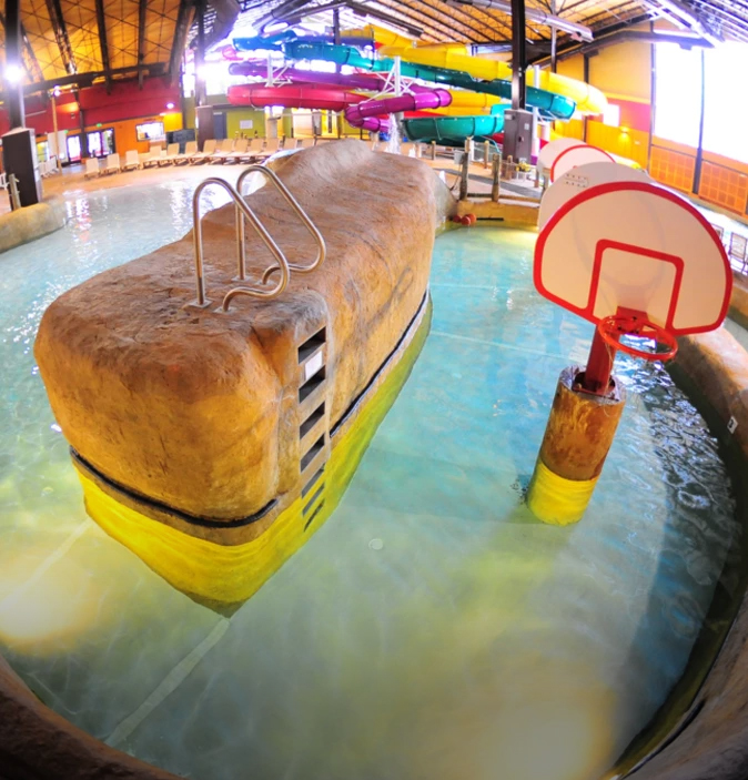 a large indoor water park with a large rock pool