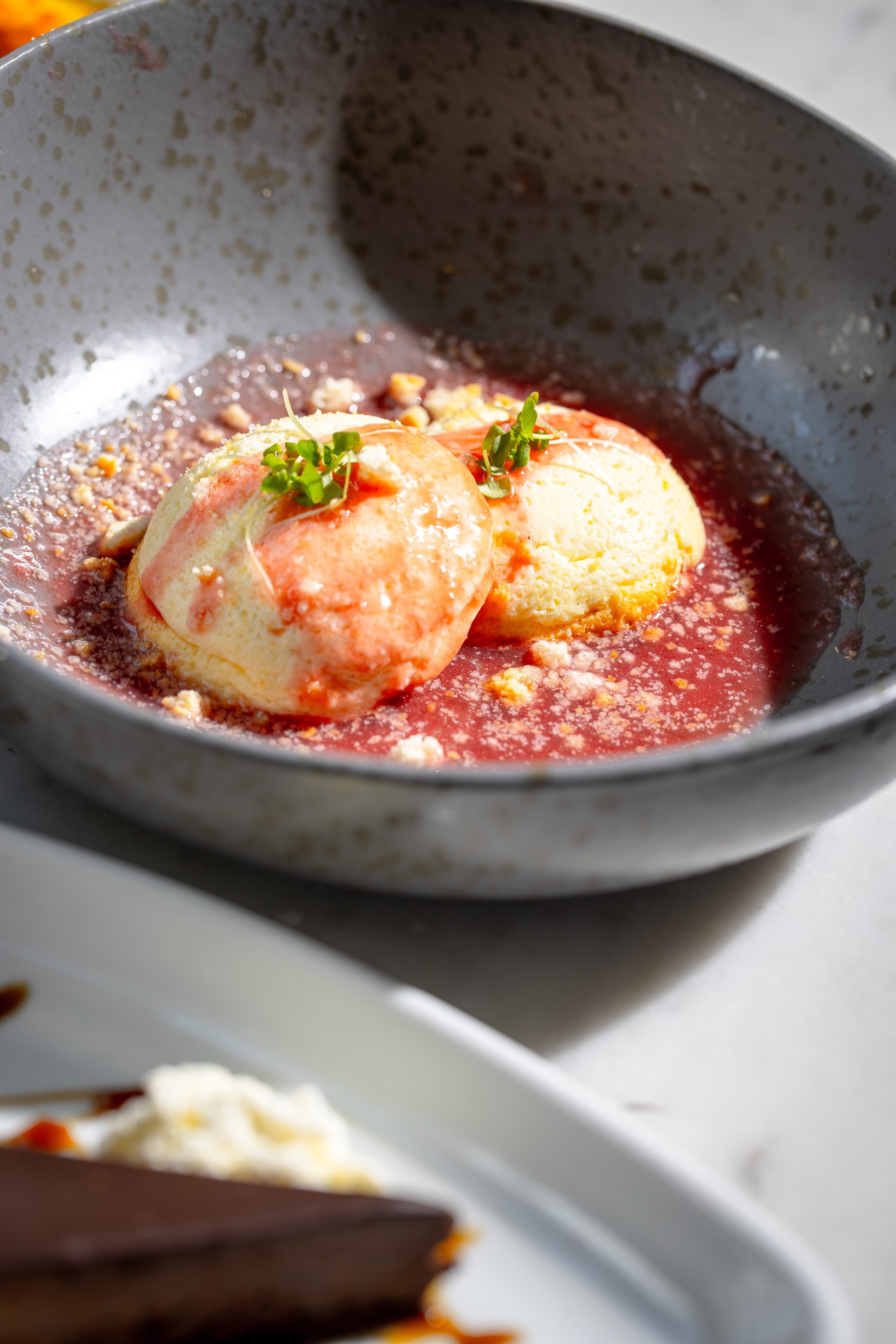 a bowl of food with a couple of balls on top