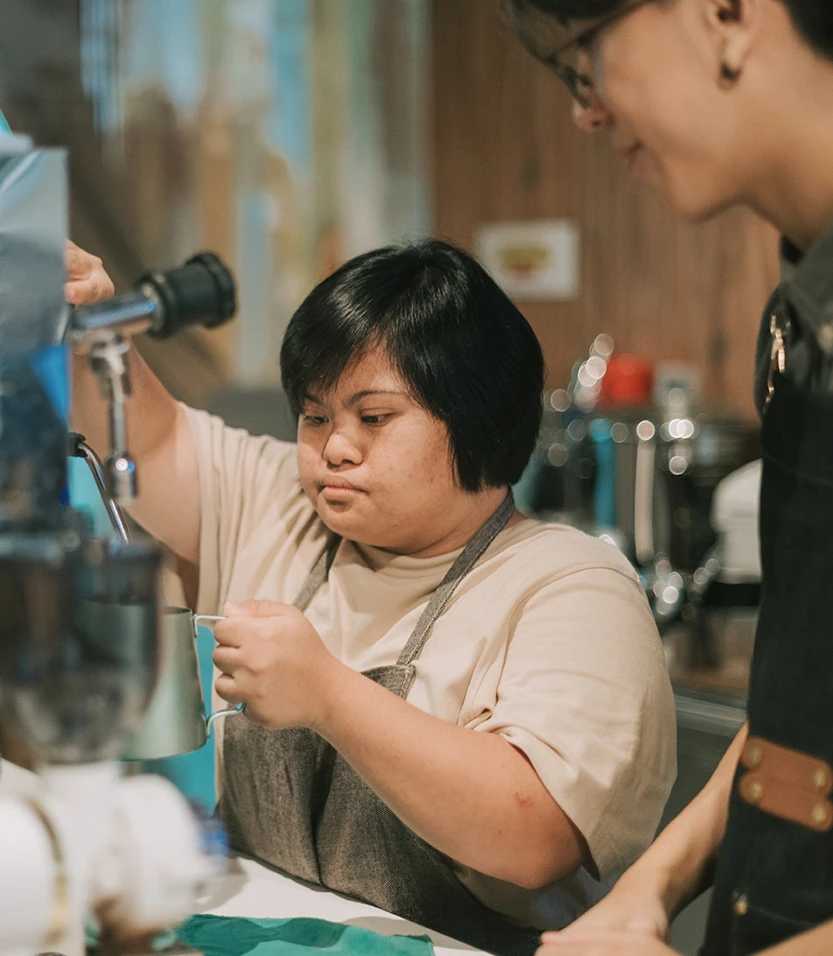 a woman working on a coffee machine