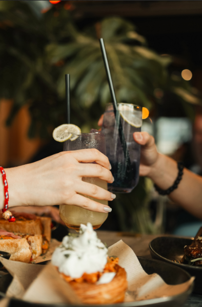 a pair of hands holding drinks