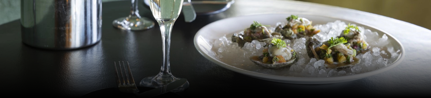 a glass of champagne next to a plate of food