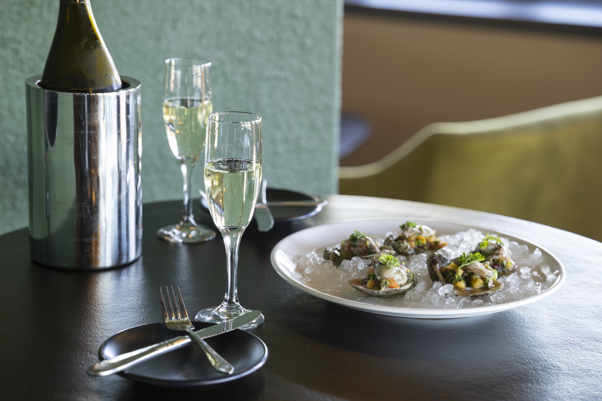 a plate of food on a plate with ice and champagne glasses