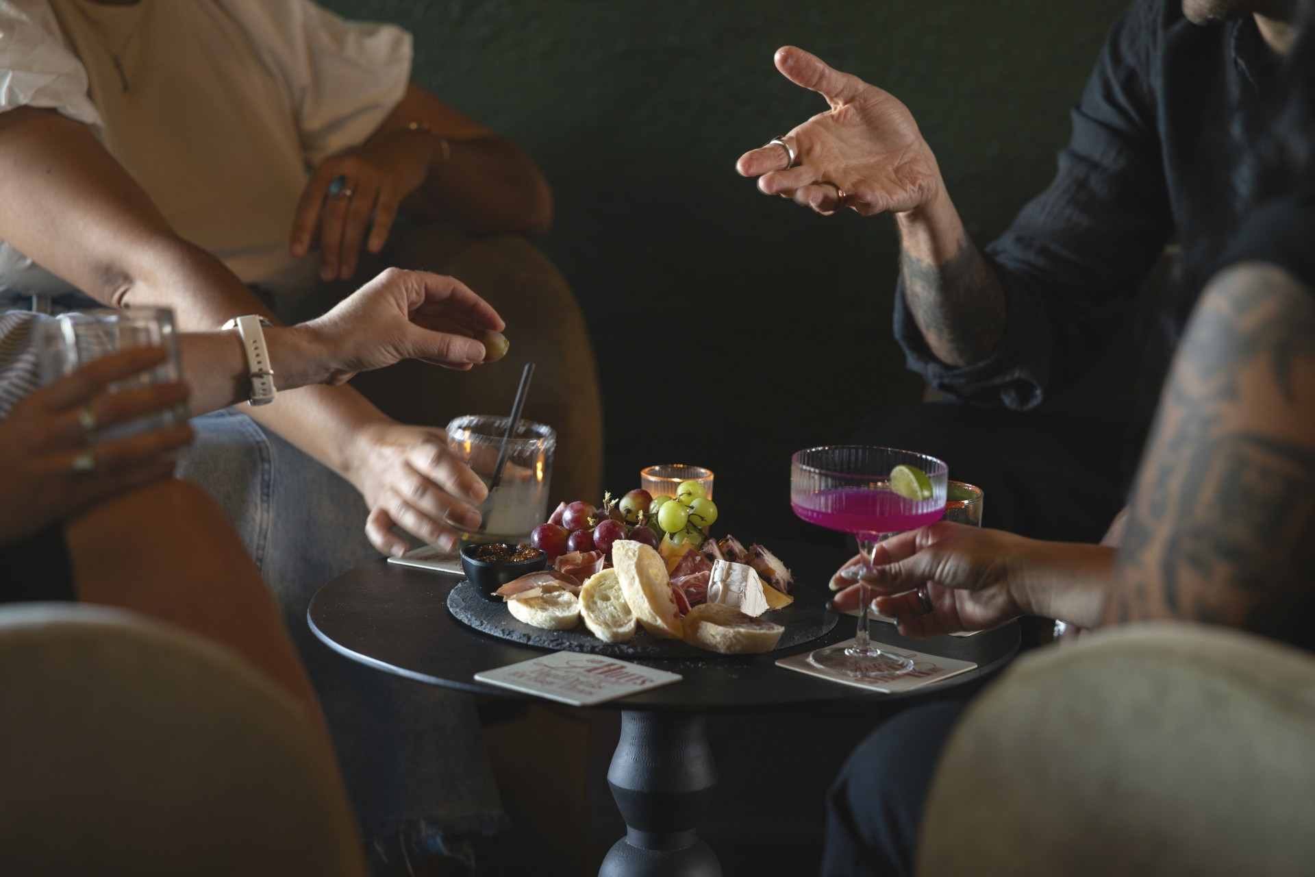 a group of people sitting around a table with food