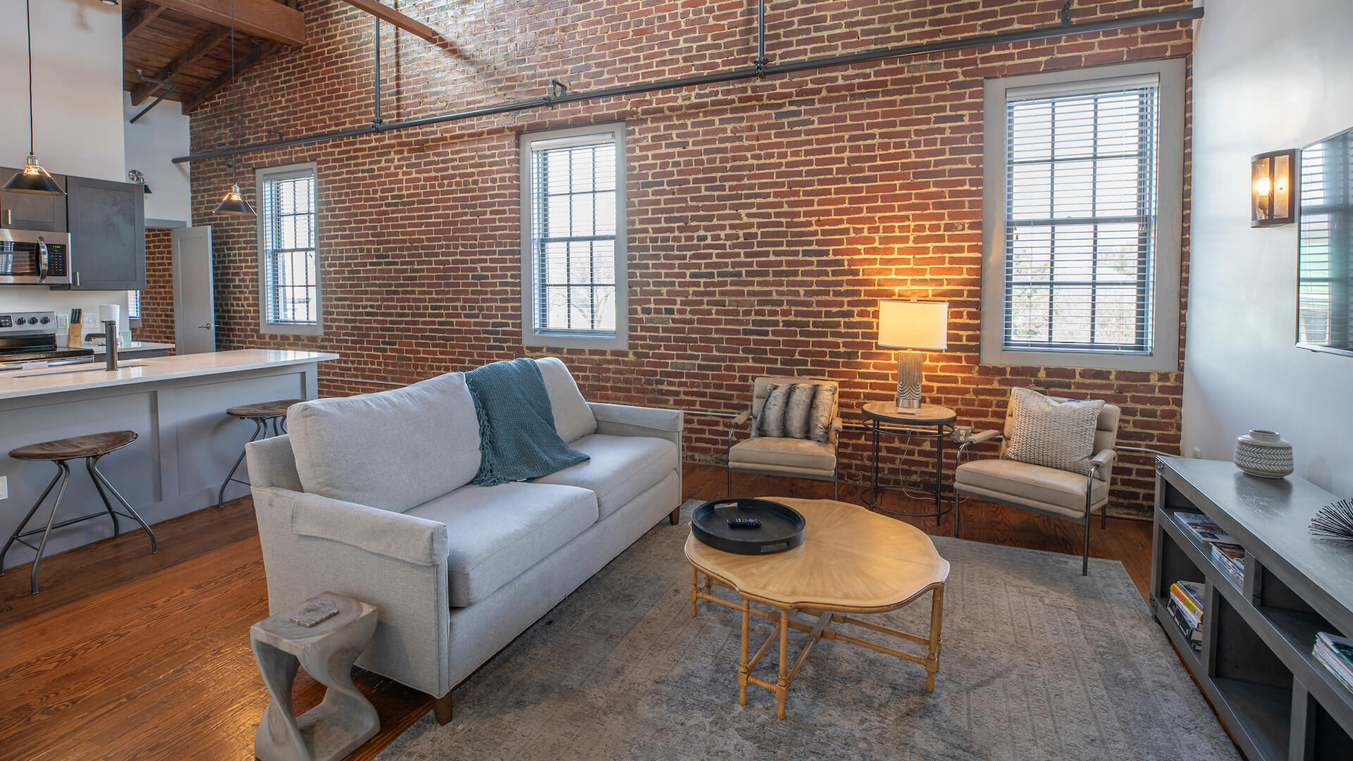 a living room with a brick wall and a couch