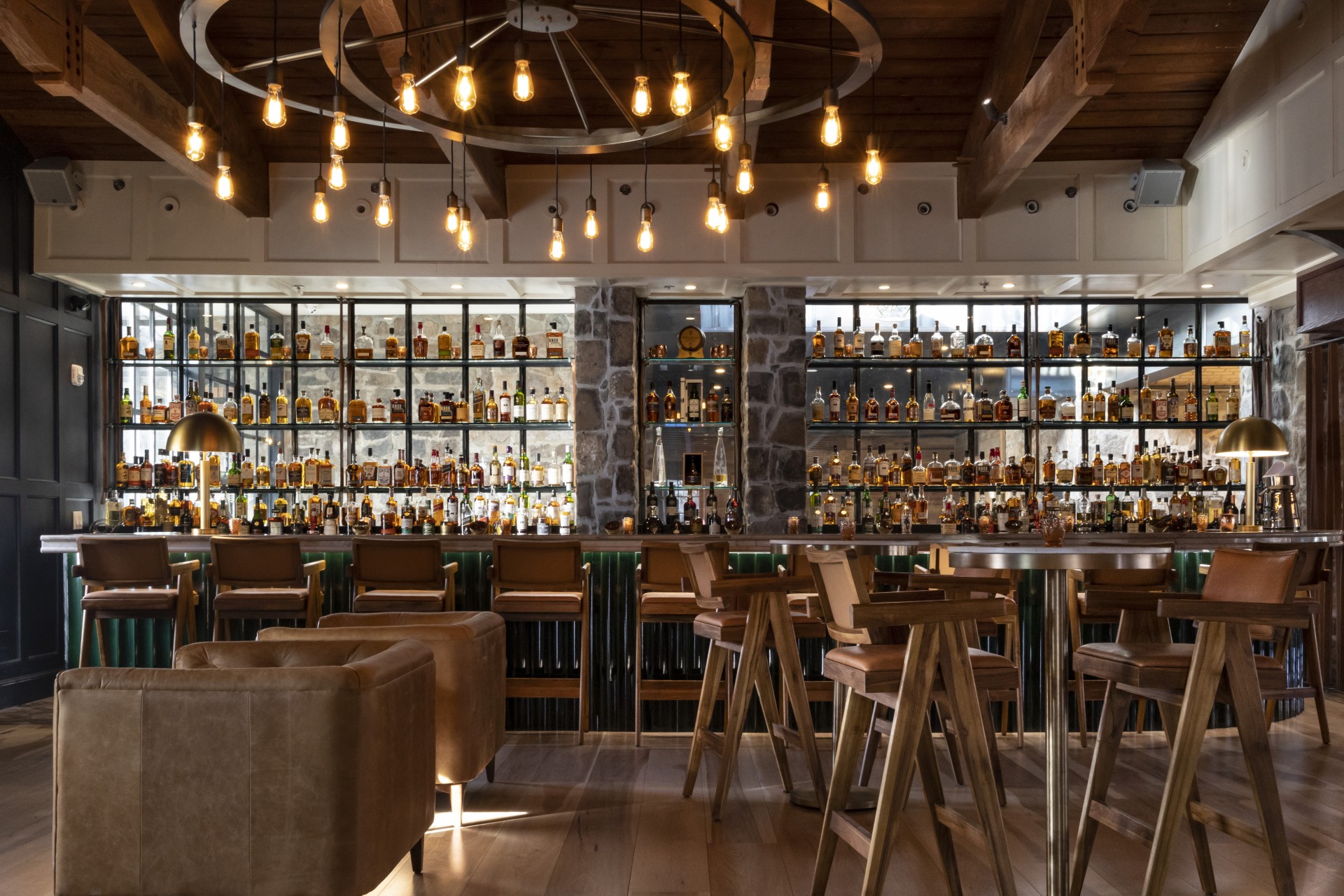 a bar with a counter and bar stools and lights