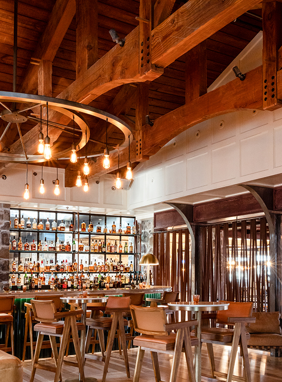 a bar with a bar and a shelf of liquor