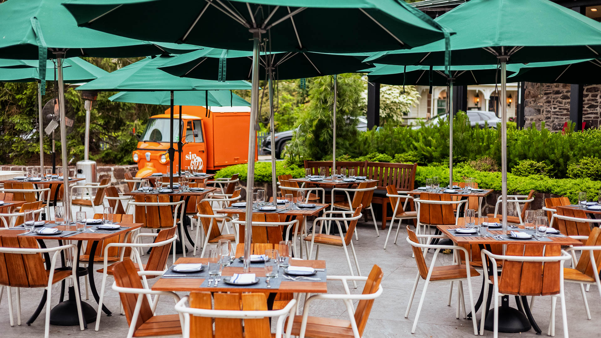 tables and chairs under umbrellas