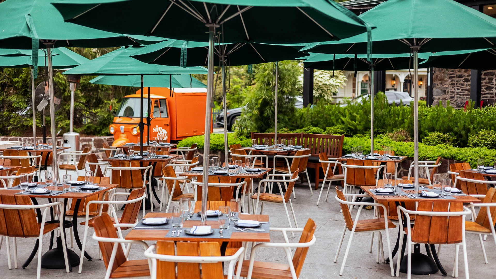 tables and chairs under umbrellas