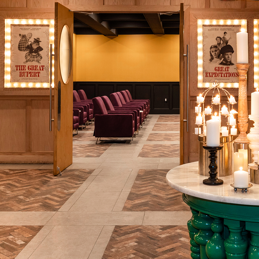 a room with chairs and a table with candles