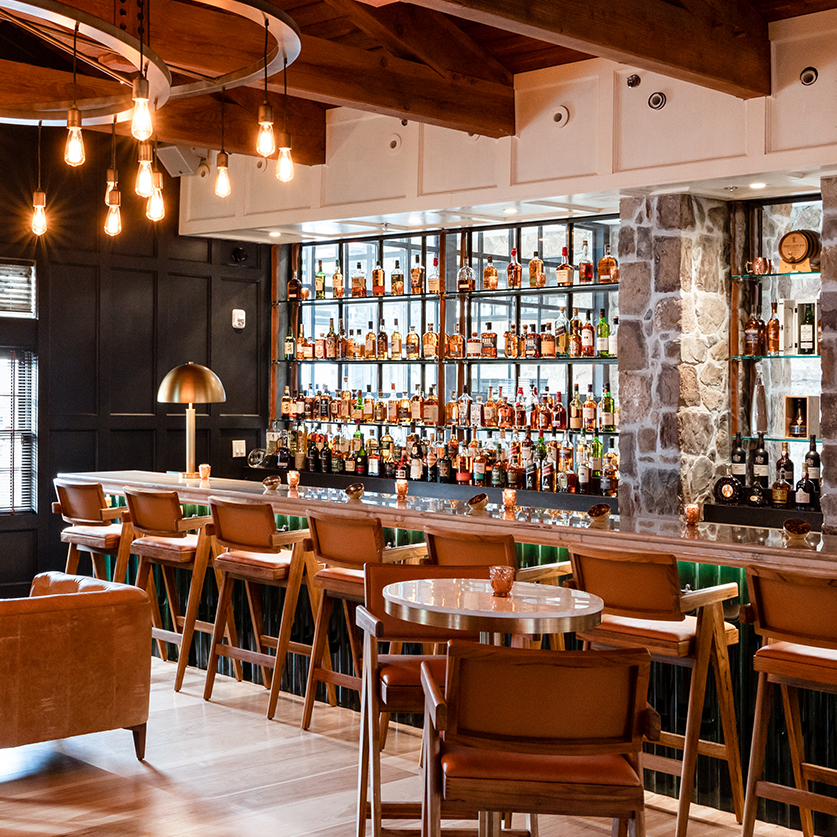 a bar with a bar and chairs