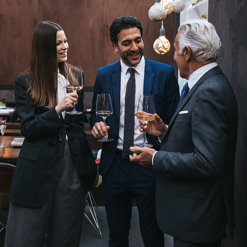 a group of people holding wine glasses