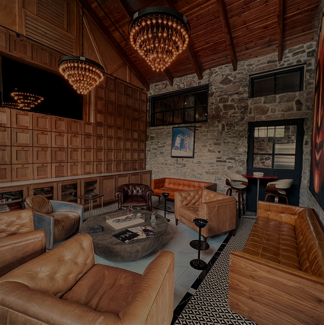 a room with leather furniture and a chandelier