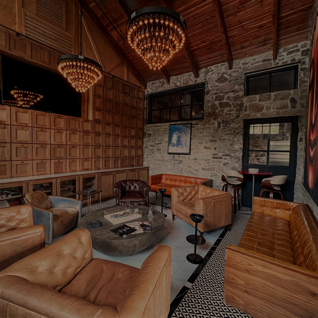 a room with leather furniture and a chandelier