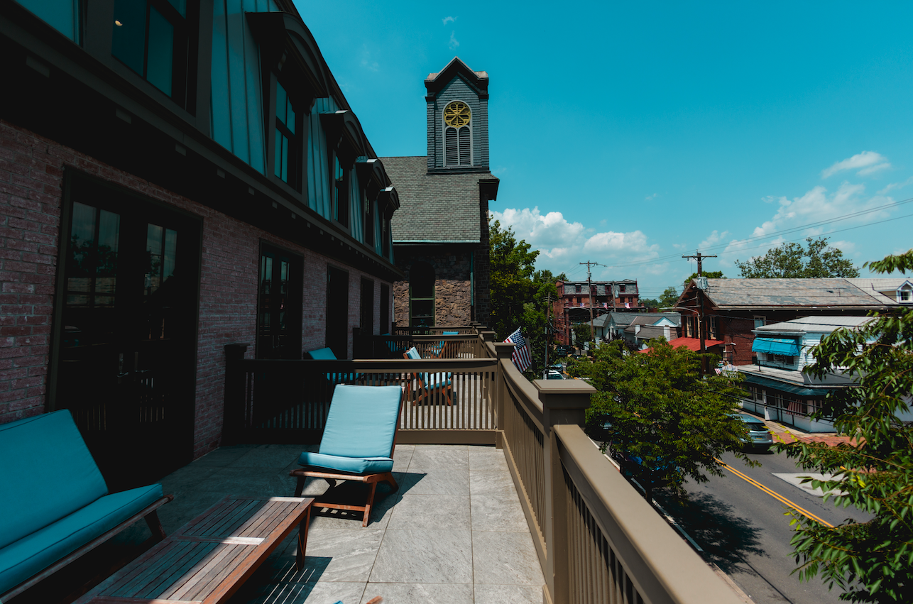 a deck with chairs and a clock tower