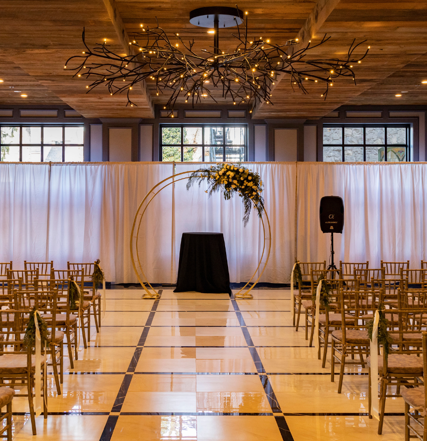 a room with chairs and a large chandelier