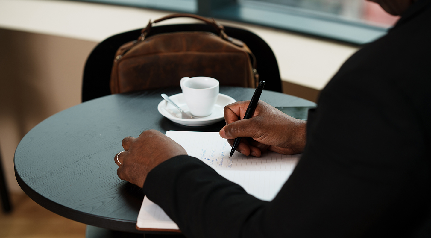 a person writing on a piece of paper