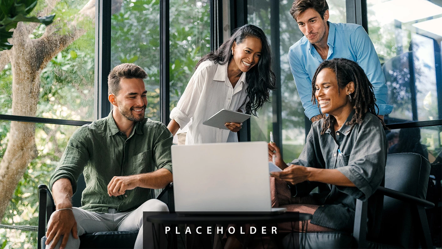 a group of people looking at a laptop