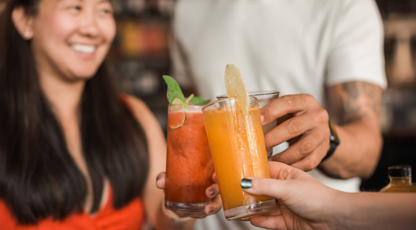a group of people holding drinks
