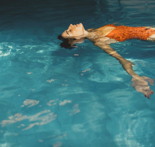 a woman floating in a pool