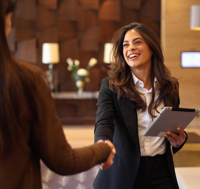 a woman shaking hands with another woman