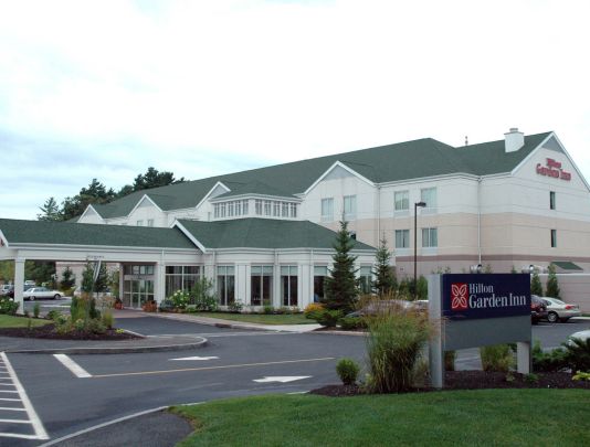 a hotel with a sign in front of it