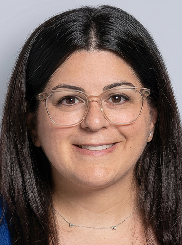 a woman with glasses smiling