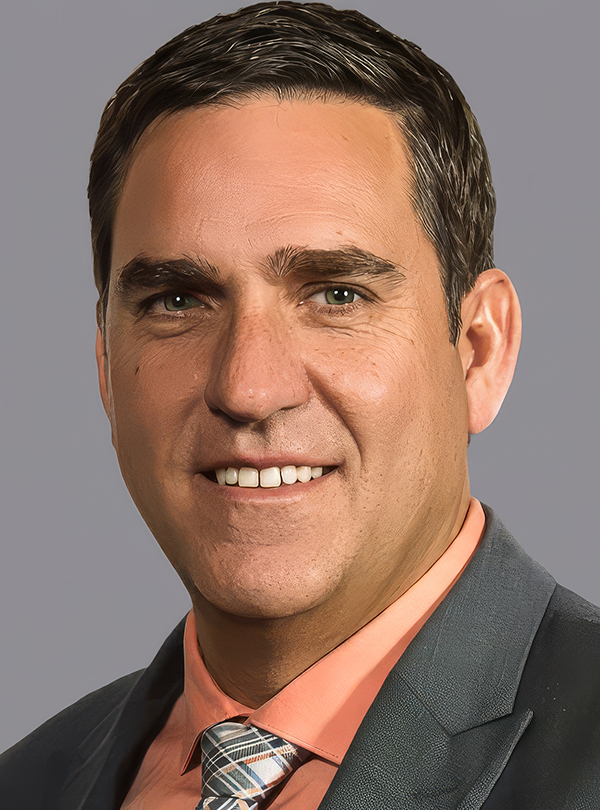 a man in a suit smiling