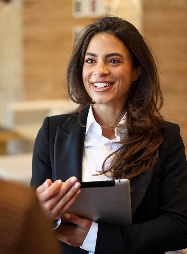 a woman in a suit holding a tablet